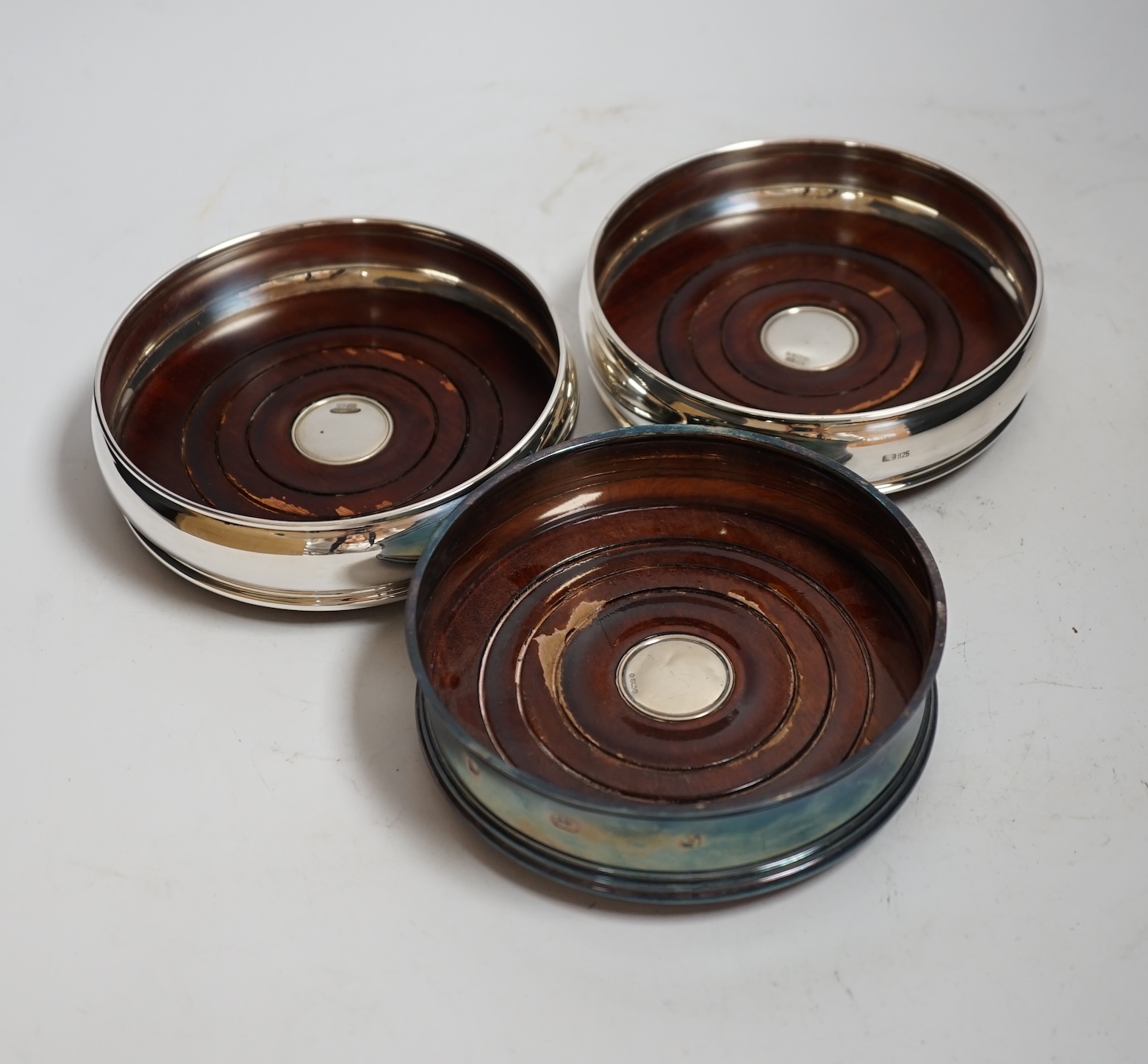 Six modern silver mounted wine coasters, including pierced pair, London, 2009, diameter 12.5cm, three boxed in total.